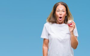 woman holding a cupcake with surprised face dentist in dentist in Columbia South Carolina